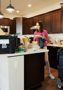 woman in pink long sleeve shirt standing in kitchen