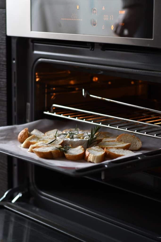 oven, bread with meat on black tray
